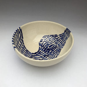 white ceramic bowl with cobalt blue patterns of lines and dots