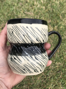 White coffee or tea mug with black and white diagonal line design.