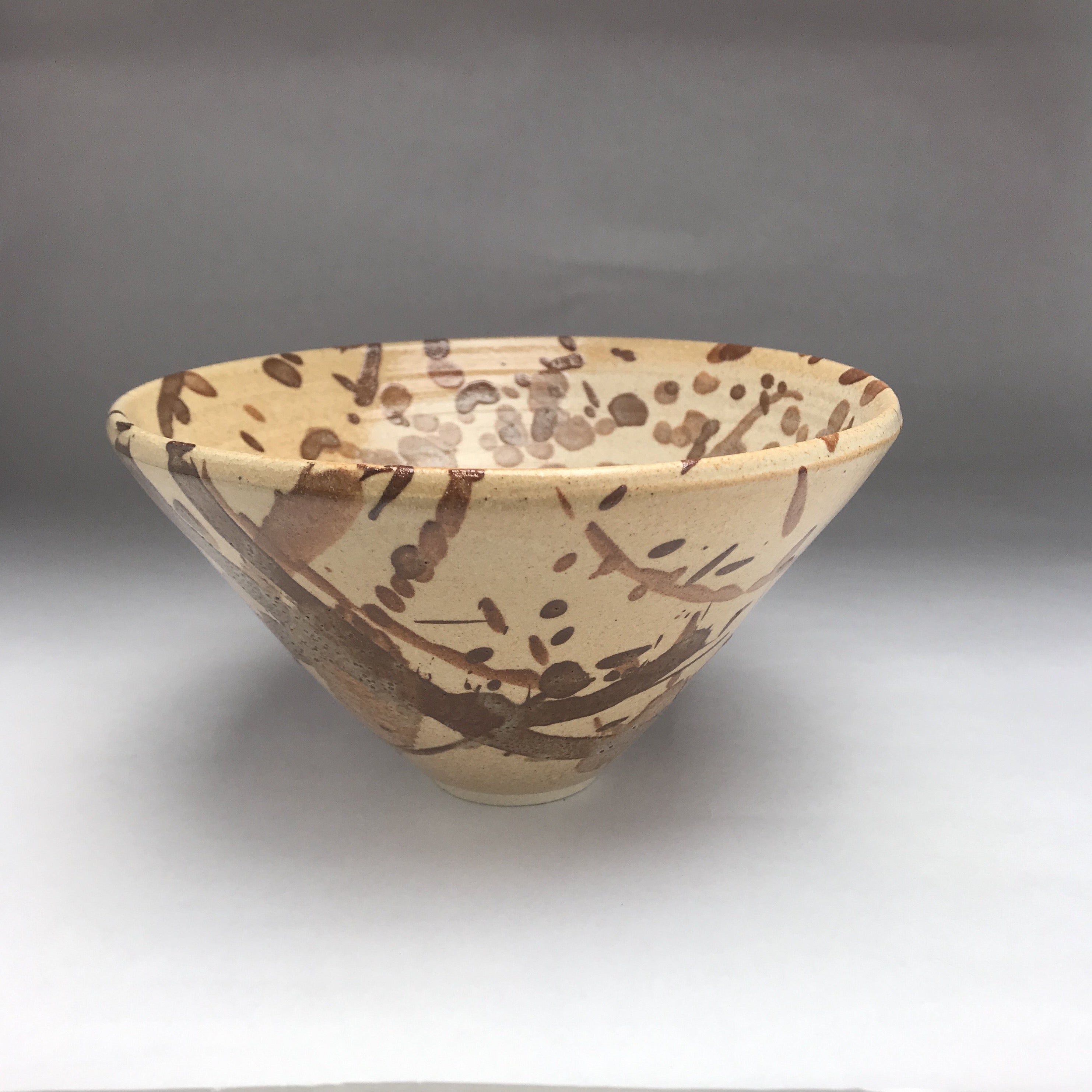 ceramic pottery bowl pale brown with dark brown splatters and splashes